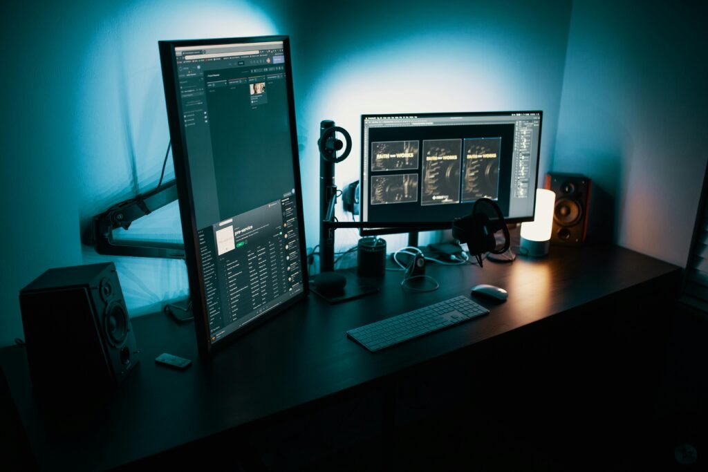 Home A contemporary office desk featuring a dual monitor setup with stylish lighting, ideal for tech enthusiasts.